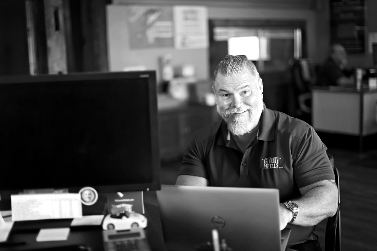 Tampa area metal roofing business development manager, Ron Fuller at desk